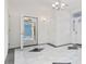 Foyer with marble tile floor, chandelier, and a view into another room at 4552 River Rd., Little River, SC 29566
