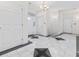 Grand foyer featuring marble tile floor, chandelier, and multiple doors at 4552 River Rd., Little River, SC 29566