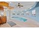 Indoor pool with ceiling fan and multiple windows to let light in at 4552 River Rd., Little River, SC 29566
