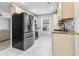 Modern kitchen with stainless steel appliances, including a refrigerator and adjacent living space at 462 Wallingford Circle, Myrtle Beach, SC 29588