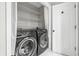Convenient laundry area with black front-loading washer and dryer and ample shelving at 462 Wallingford Circle, Myrtle Beach, SC 29588