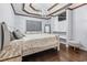 Elegant main bedroom featuring tray ceiling, a chandelier, and hardwood floors at 462 Wallingford Circle, Myrtle Beach, SC 29588
