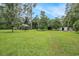 Expansive backyard with lush greenery, a shed, and a gazebo, ideal for outdoor activities at 475 Willard Rd., Conway, SC 29526