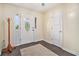 Bright foyer with an ornate front door, dark wood floors, and a coat rack, providing an elegant entrance at 475 Willard Rd., Conway, SC 29526