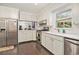 Bright kitchen showcasing white cabinets, stainless steel appliances, and a view to the yard at 475 Willard Rd., Conway, SC 29526