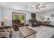 Cozy living room featuring comfortable seating, a ceiling fan, and access to a deck, perfect for relaxation at 475 Willard Rd., Conway, SC 29526