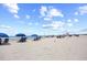 Beach with people, umbrellas and a lifeguard stand during a sunny day at 4800 S Ocean Blvd. # 514, North Myrtle Beach, SC 29582