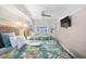 Bright bedroom featuring two beds with tropical themed bedspreads and ceiling fan at 4800 S Ocean Blvd. # 514, North Myrtle Beach, SC 29582