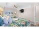 Well-lit bedroom featuring two beds with tropical themed bedspreads, ceiling fan and TV at 4800 S Ocean Blvd. # 514, North Myrtle Beach, SC 29582