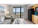 Cozy living area flowing to the kitchenette and a balcony with views of the ocean and beach at 4800 S Ocean Blvd. # 514, North Myrtle Beach, SC 29582