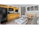 View of living room blending into kitchenette, with wooden floors and natural wood cabinets at 4800 S Ocean Blvd. # 514, North Myrtle Beach, SC 29582