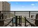 View of a balcony featuring adirondack chairs and a small table overlooking the beach at 4800 S Ocean Blvd. # 920, North Myrtle Beach, SC 29582