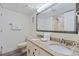 Bright bathroom with a double vanity, granite countertop, modern fixtures, and a large mirror at 4800 S Ocean Blvd. # 920, North Myrtle Beach, SC 29582