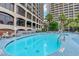 Exterior view of an outdoor swimming pool with several lounge chairs at 4800 S Ocean Blvd. # 920, North Myrtle Beach, SC 29582