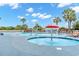 Inviting outdoor pool and splash fountain surrounded by lounge chairs and palm trees at 4800 S Ocean Blvd. # 920, North Myrtle Beach, SC 29582