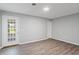 Bedroom area includes wood floors, a white wall paint with a door leading to a yard at 482 Greenview Dr. # 5B, Johnsonville, SC 29555