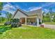View of backyard showing outdoor seating with lawn and driveway to side of home at 4867 Wolf Trail, Conway, SC 29527