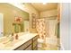 Bathroom featuring a single sink vanity, framed artwork and a shower-tub combo at 4867 Wolf Trail, Conway, SC 29527
