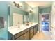 Bathroom with dual sinks, a large mirror, and doorway leading to the bedroom at 4867 Wolf Trail, Conway, SC 29527