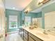 Bathroom featuring double vanity, a large mirror, two windows, and neutral-colored walls at 4867 Wolf Trail, Conway, SC 29527