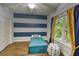 Bedroom featuring blue and grey striped walls, a ceiling fan, and decorated with nautical decor at 4867 Wolf Trail, Conway, SC 29527