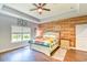 Bedroom with wood accent wall, tray ceiling, ceiling fan, and a bright window at 4867 Wolf Trail, Conway, SC 29527