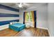Bedroom with blue and grey striped walls, ceiling fan, and nautical-themed decor at 4867 Wolf Trail, Conway, SC 29527