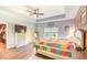 Bright bedroom features a wood accent wall, tray ceiling, ceiling fan, and an attached walk-in closet at 4867 Wolf Trail, Conway, SC 29527