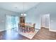 Dining room with a large wooden table, classic chandelier, and access to the living area at 4867 Wolf Trail, Conway, SC 29527