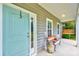 Inviting front porch with a bench, swing and a blue front door creating a cozy outdoor space at 4867 Wolf Trail, Conway, SC 29527