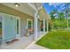 Charming front porch with white pillars, swing and welcome decor at front door entrance at 4867 Wolf Trail, Conway, SC 29527