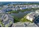 Aerial view of a community with a pond surrounded by trees and buildings at 4894 Luster Leaf Circle # 403, Myrtle Beach, SC 29577