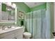 Fresh bathroom featuring mint green walls, bright mirror, and shower with curtain at 4894 Luster Leaf Circle # 403, Myrtle Beach, SC 29577