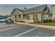 Exterior of the community clubhouse with parking and lush landscaping at 4894 Luster Leaf Circle # 403, Myrtle Beach, SC 29577