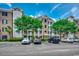 Condo exterior with brick accents, white trim, mature trees, and convenient parking at 4894 Luster Leaf Circle # 403, Myrtle Beach, SC 29577