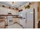 Well-lit kitchen with white appliances, ample counter space, and decorative touches at 4894 Luster Leaf Circle # 403, Myrtle Beach, SC 29577