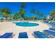 Beautiful community swimming pool with lounge chairs, surrounded by a white fence and tall trees at 4894 Luster Leaf Circle # 403, Myrtle Beach, SC 29577