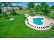 Community pool surrounded by lounge chairs and lush green landscaping, perfect for relaxation at 4894 Luster Leaf Circle # 403, Myrtle Beach, SC 29577