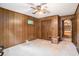 View of the basement showcasing paneled walls, a closet, and an open doorway leading to another room at 4920 Meadow St., Loris, SC 29569