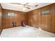 Spacious basement featuring wood paneled walls, a ceiling fan, and a small wall-mounted fireplace at 4920 Meadow St., Loris, SC 29569