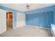 Blue bedroom featuring a closet, a window and an entrance to another room at 4920 Meadow St., Loris, SC 29569