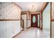 Inviting entryway features a chandelier, wood trim, and stairs leading upstairs to other bedrooms at 4920 Meadow St., Loris, SC 29569