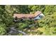 Charming home nestled amongst mature trees with a well-manicured yard and a brick walkway leading to the front door at 4920 Meadow St., Loris, SC 29569
