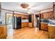 Kitchen featuring wood cabinets, a stained glass light fixture, and a black refrigerator, stove, and microwave at 4920 Meadow St., Loris, SC 29569