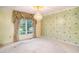 Open living room featuring classic decor, a chandelier, and a large window letting in tons of natural light at 4920 Meadow St., Loris, SC 29569