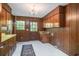 Mud room with wood-paneled walls, ample cabinet space, a sink, and a door leading to the outside at 4920 Meadow St., Loris, SC 29569