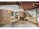 Screened porch with a wood ceiling, ceiling fan, brick walls, and access to the backyard at 4920 Meadow St., Loris, SC 29569