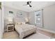 Bright bedroom featuring a ceiling fan, tray ceiling, light wood floors and two bedside tables at 558 Oxbow Dr., Myrtle Beach, SC 29579