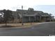 Community clubhouse featuring detailed architecture, lush landscaping, and ample parking at 558 Oxbow Dr., Myrtle Beach, SC 29579