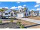 Stunning two-story home with a well-manicured lawn, a driveway, and an attached two-car garage at 558 Oxbow Dr., Myrtle Beach, SC 29579